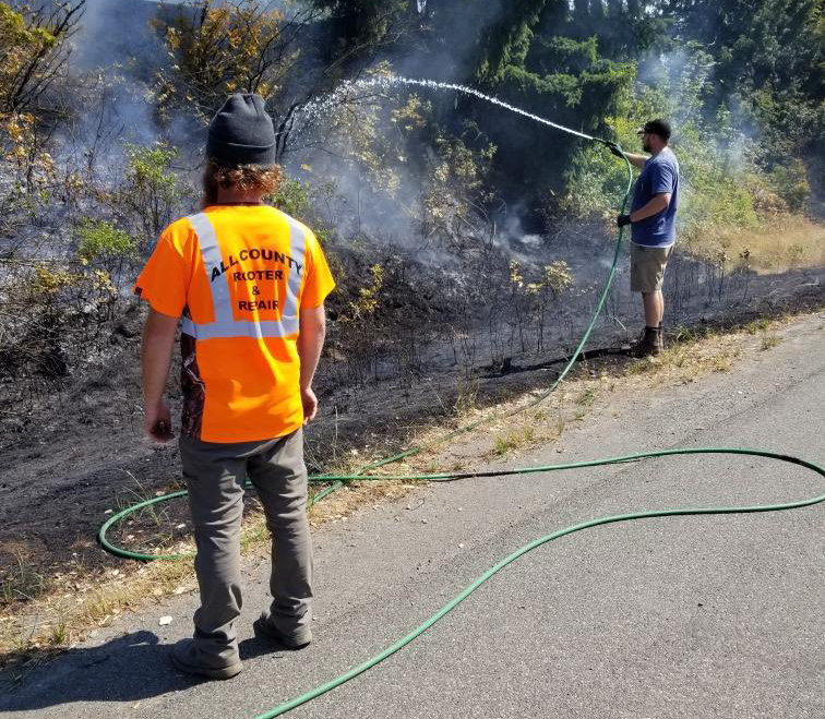Trooper Robert Reyer posted this photo to Twitter along with this message: "I just learned that these guys from All County Rooter & Repair, who had been traveling south on I-5, turned to help avoid the fire from spreading into the fir trees on the northbound side before fire arrived! They had a 500 gallon water trailer."